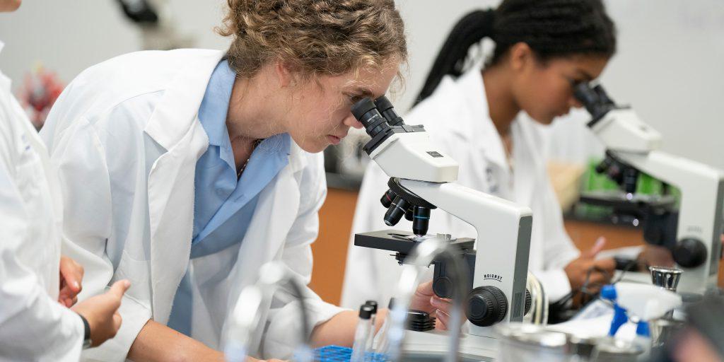 students looking through microscope, private school, tampa fla